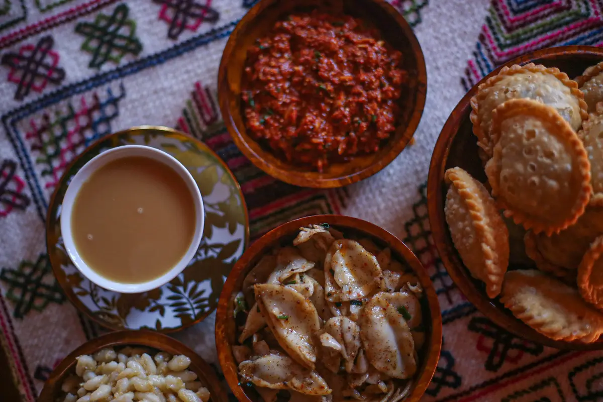 Ema datshi, red rice, and mountain vegetables — the Bhutanese table, where the chilli is the main event