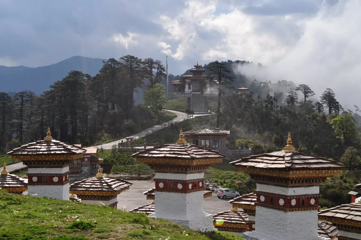 Dochula Pass in Bhutan with 108 memorial chortens surrounded by monsoon mist and clouds