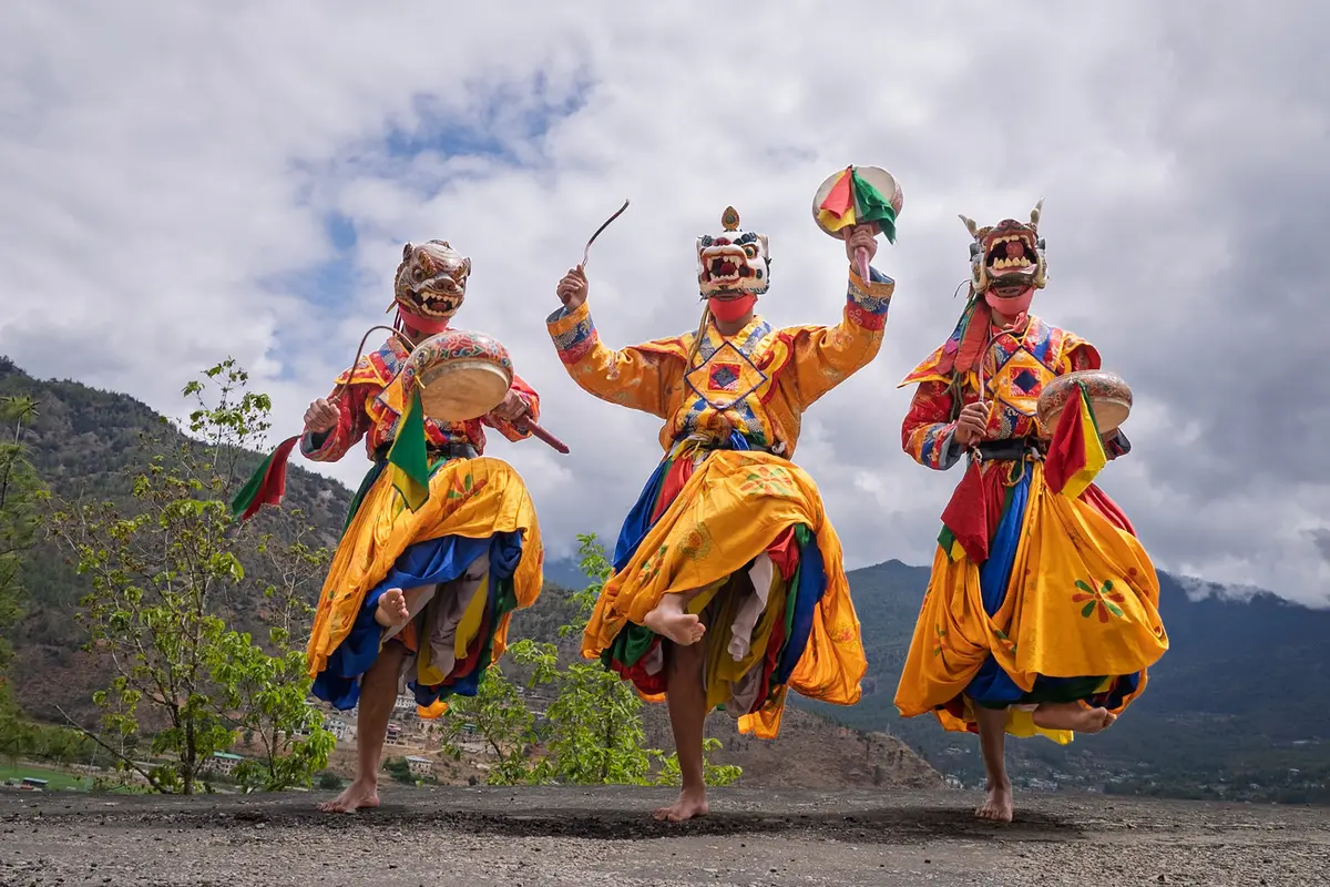 Masked cham dancers at a Bhutanese tshechu — sacred choreography passed down unbroken for centuries