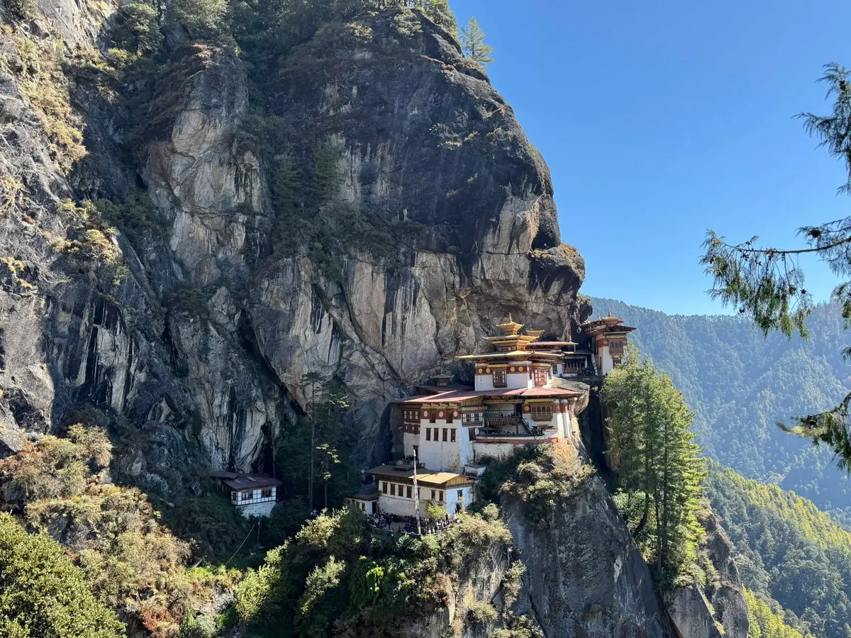 Tiger's Nest monastery on its cliff face above Paro — rebuilt after the 1998 fire, luminous as ever